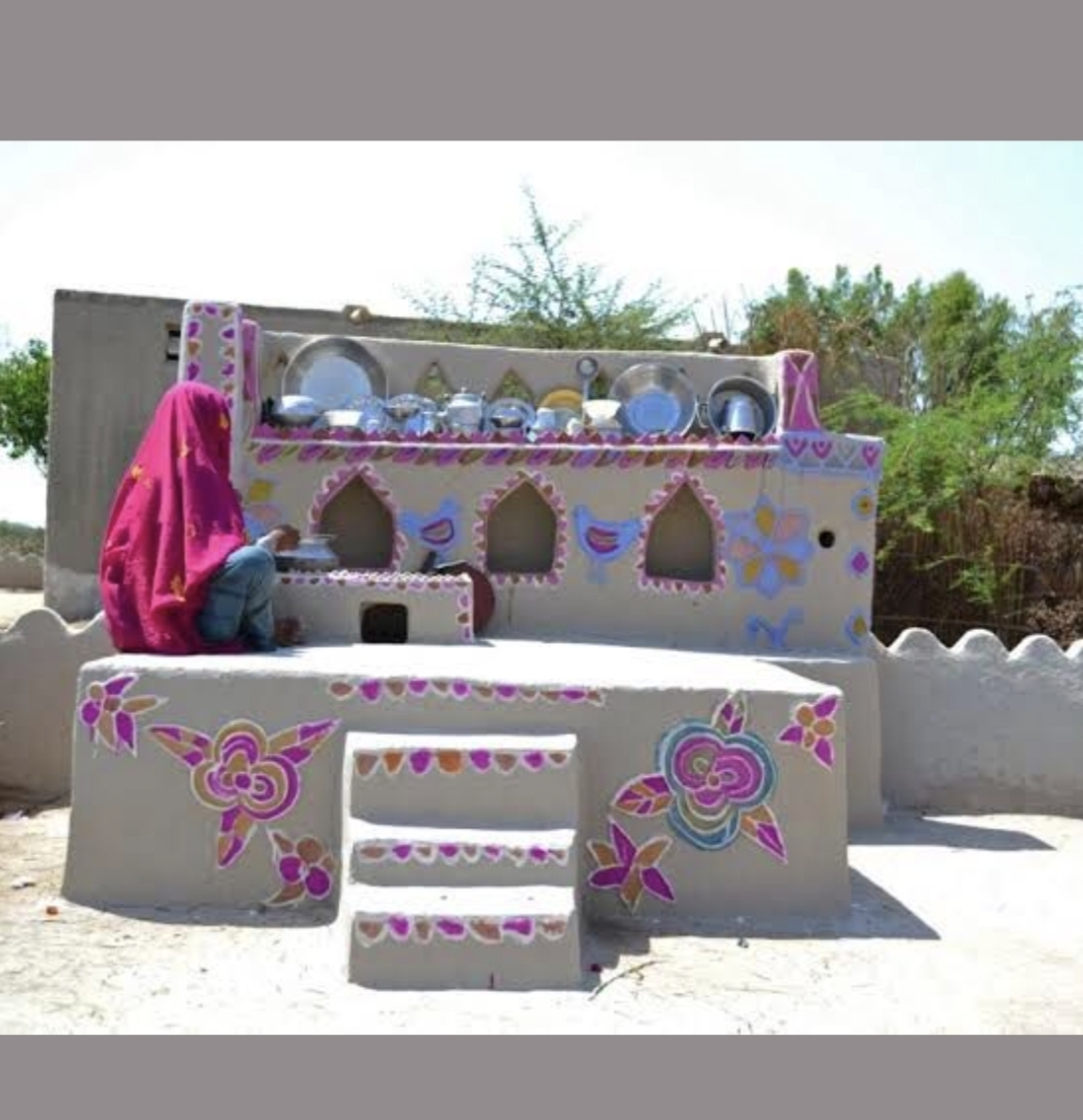 Colorfully decorated traditional village mud kitchen with floral motifs