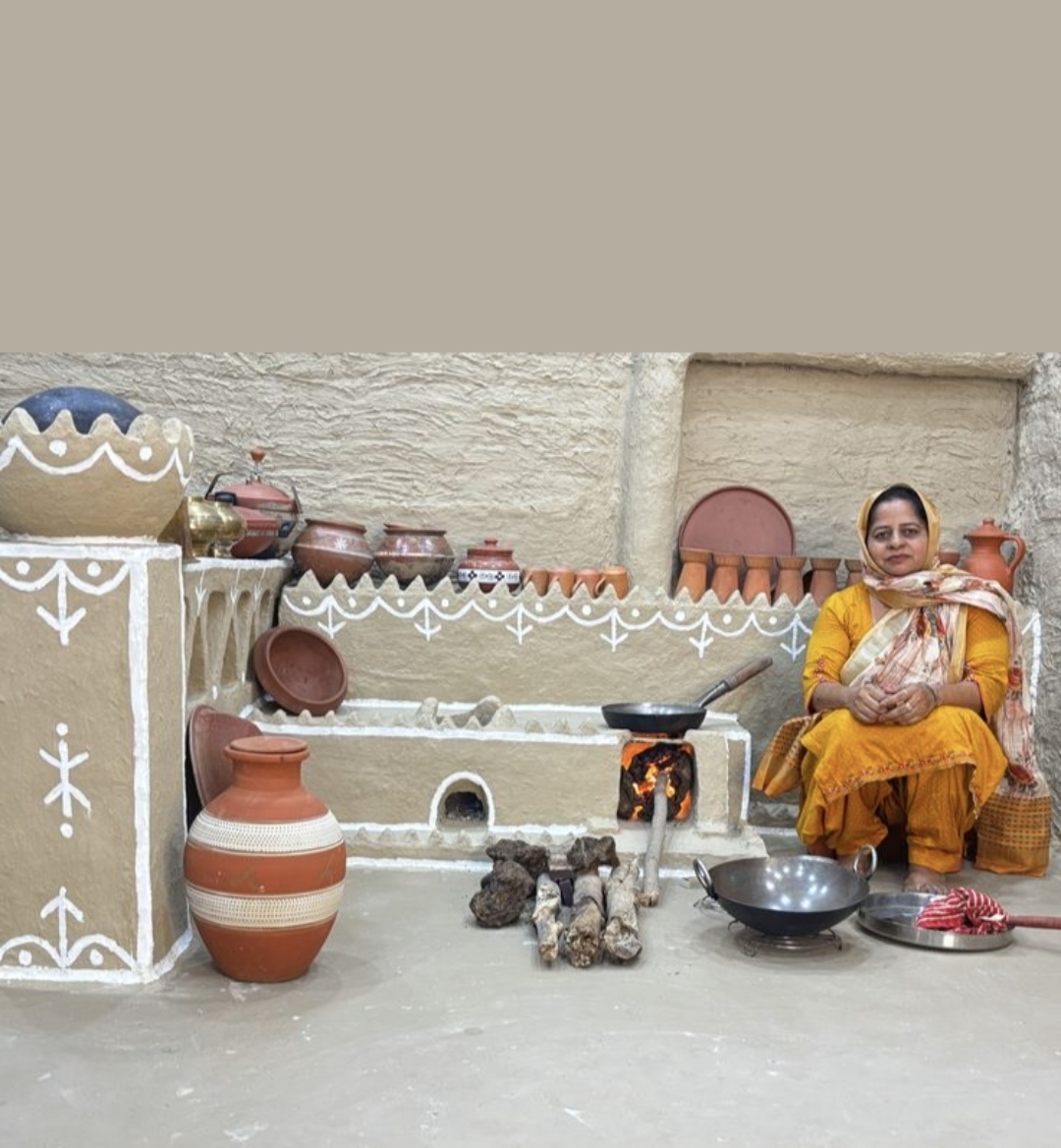 Artisan-styled mud kitchen with terracotta pots, chulha and folk art